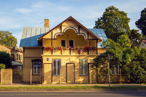 Traditional wooden house with flower balcony in Maskavas Forstate, Riga
