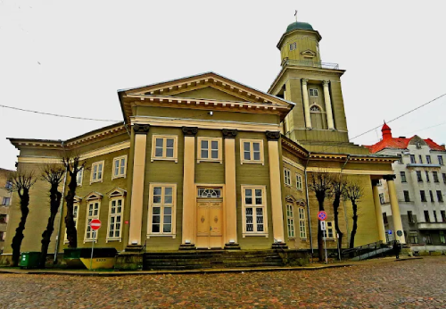 Neoclassical building on cobblestone square in old Riga